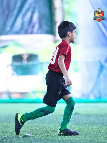Building champions, one session at a time. A young player runs through a drill, focused on the task at hand.