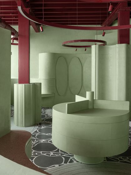 The contrast between the dark, graphic floor and the light, sculptural walls is a key feature of this award-winning retail design.