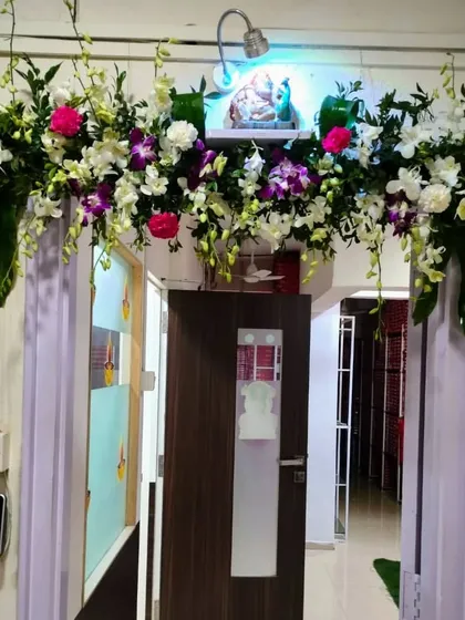 An elegant and modern door decoration using white and purple orchids. This sophisticated arrangement is perfect for those looking for a subtle yet beautiful way to adorn their entrance for a special event.