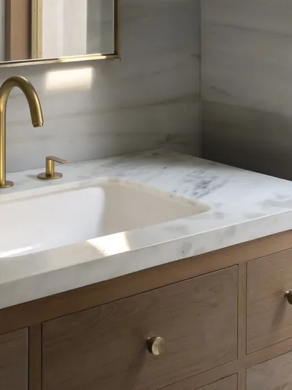 Even the smallest elements are an opportunity for thoughtful design. These custom brass knobs, seen here on a bathroom vanity, carry the material language of brass and wood into every corner of the DUA Villa.