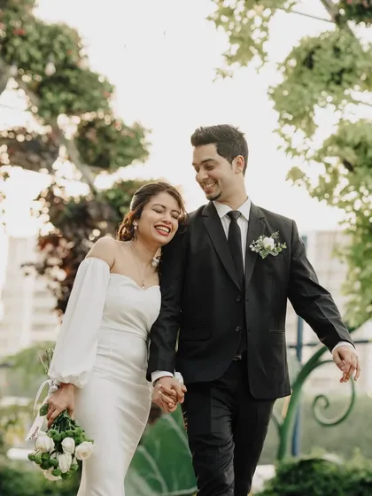 An elopement is a profoundly personal affair, and I aim to capture that intimacy. Here, Charlene and Dexter share a happy, relaxed moment after their ceremony in Dubai, their joy lighting up the beautiful garden setting.