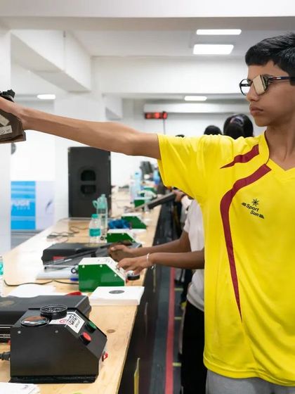 A young pistol shooter demonstrates classic form and a steady hand during a competitive match. Our training covers both air rifle and air pistol disciplines.