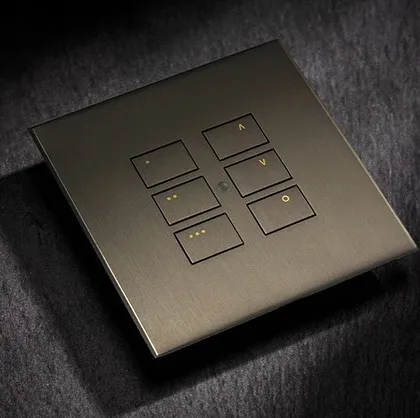 The EOS range from Rako Controls features a timeless design with easy-to-use, custom-engraved buttons. This keypad, shown in a dark metallic finish, offers intuitive control over lighting levels and scenes.