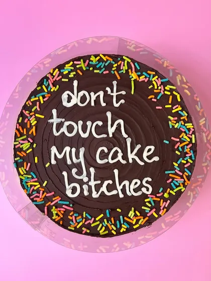 A friendly reminder for your party guests. This is a classic chocolate fudge cake with a very clear, sassy message written in buttercream. If you want a cake that says what everyone's thinking, you know who to call.