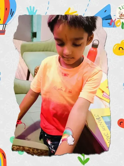 Getting a temporary tattoo is one of the fun perks during our festival events! This boy is showing off his cool rainbow tattoo from our Rakhi celebration.
