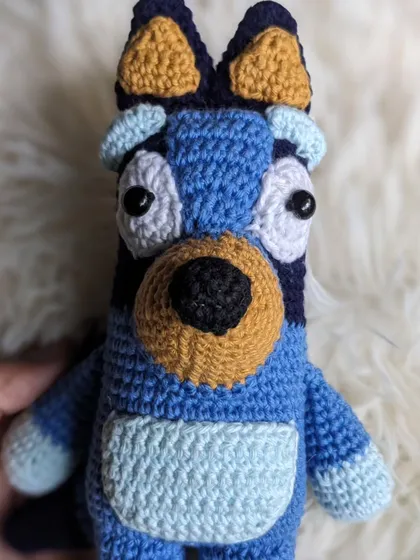A detailed close-up of the Bluey doll's expressive eyes.