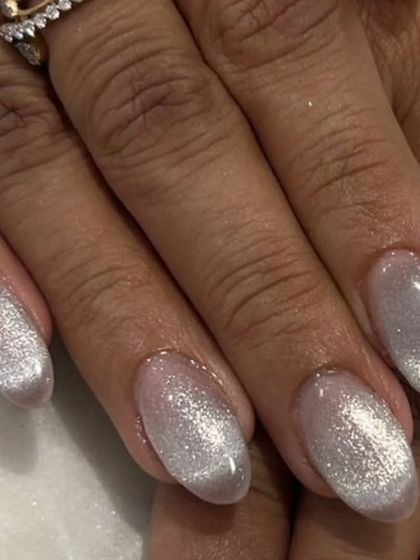 A detailed shot of the silver-white cat-eye polish. It's a beautiful option for a bridal manicure or any time you want an elegant, shimmering look.