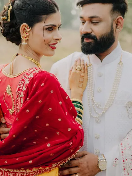 A close-up that highlights the bride's stunning traditional jewelry and the couple's affectionate gaze. The details of her attire and their expressions tell a story of love and heritage.