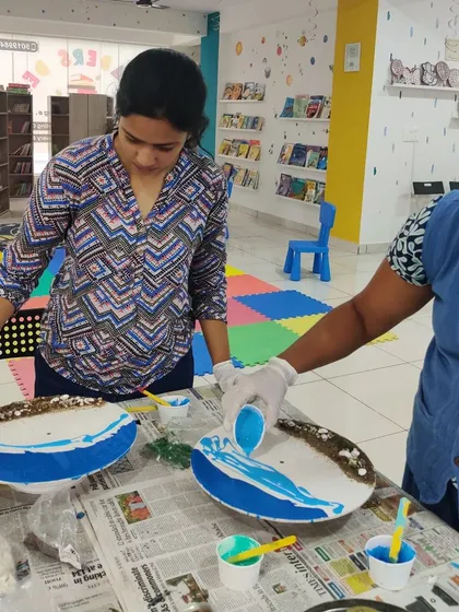 Two women collaborating and learning the fluid art of resin pouring during one of our weekend workshops.