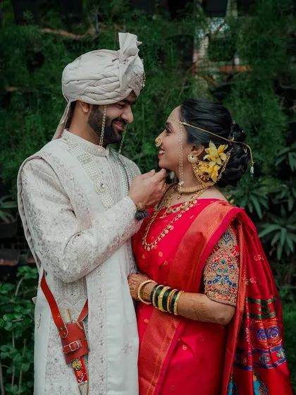 A quiet moment between the wedding rituals. I believe the most beautiful portraits are the ones that are not posed but felt, like this gentle touch that says more than words ever could. This is a classic Maharashtrian wedding couple portrait.
