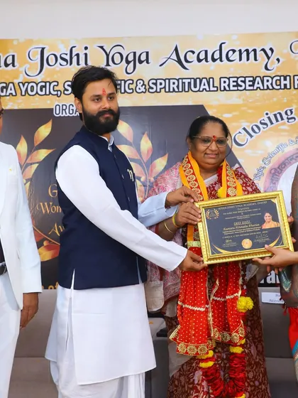 Presenting an award to a fellow yoga professional. Recognizing the contributions of others is just as important as receiving accolades.