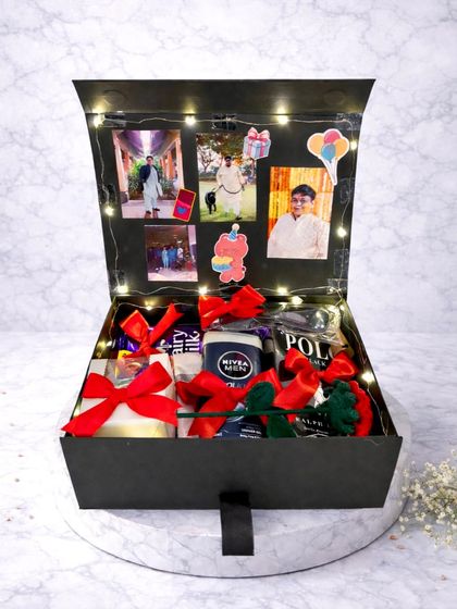 This birthday box for him is all about personalization. The lid opens to display a collection of his favorite photos, lit up with fairy lights, while the box itself is filled with grooming products and chocolates.