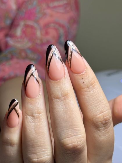 A close-up of the modern black and glitter French design, showing the clean lines and flawless application.