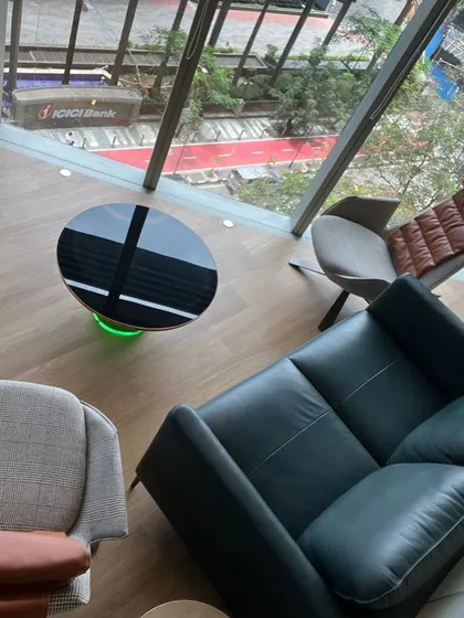 Lounge area in a modern office with a view of the street below. It provides a space for informal meetings or a moment of quiet reflection.