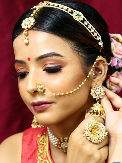 Another angle of this simple and elegant bridal look. The soft pink eyeshadow and traditional jewelry create a delicate and timeless style.