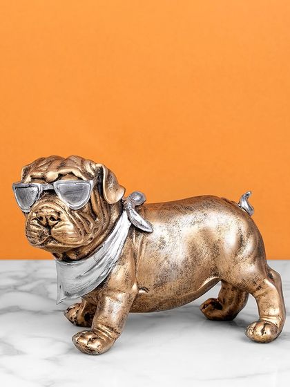 This cool bulldog figurine, with its antique bronze finish, silver scarf, and sunglasses, adds a touch of humor and style. It's a fun and quirky piece for any dog lover's home.