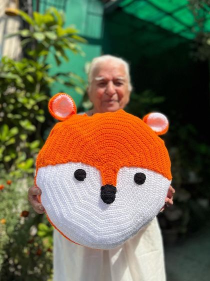 This cute fox-face cushion is a playful addition to our animal-themed collection. It's perfect for a woodland-themed nursery or kids' room.