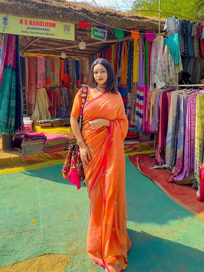 A day out at the Surajkund Mela in a comfortable orange mul cotton saree. This fabric is perfect for warm weather and exploring, as it's super lightweight and breathable.