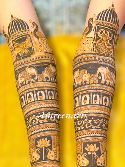 Close-up of the arm bands from a full bridal set, showcasing the royal elephant procession and palace architecture.