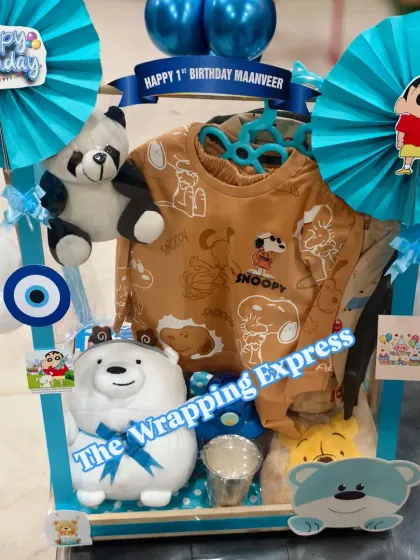 A different angle of the Shinchan birthday hamper, showing the personalized banner and cute character cutouts. I can create hampers with any cartoon theme.