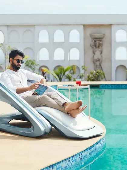 Innovation extends beyond buildings. Our custom-designed FusionWAVE Lounge Chair is a piece of functional art, showcasing our belief that great design can be a part of every object we interact with, perfect for relaxing by the pool.