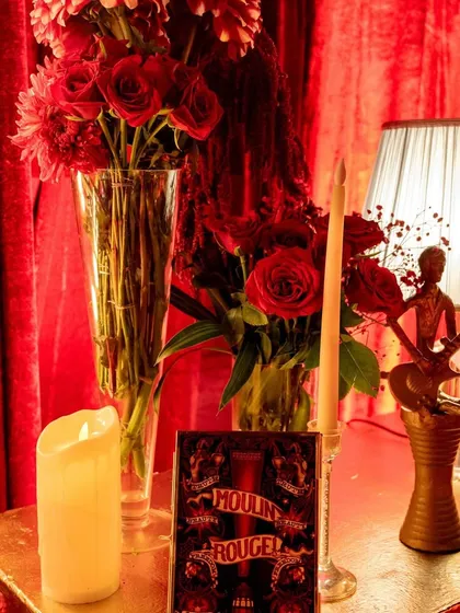 Every detail was curated to fit the theme, including this 'Moulin Rouge' inspired table accent, reinforcing the night's narrative of passionate, theatrical romance.
