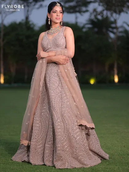 This taupe-colored lehenga with all-over geometric embroidery is understated yet glamorous. A great choice for someone who loves subtle elegance.