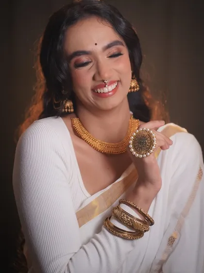 A joyful shot of the model, her smile lighting up the frame. This look is all about celebrating natural beauty with a festive touch.