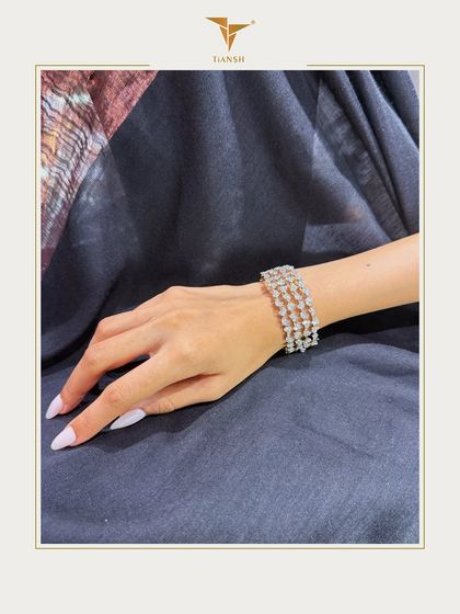 Elegance woven in brilliance. This handcrafted bracelet features a three row lattice of pear cut and round diamonds, meticulously set in 18k gold for a statement of refined luxury.