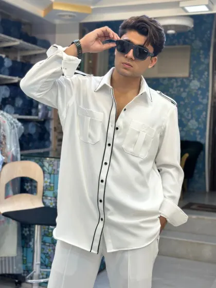 A client looking sharp in the custom white co-ord set. The black piping gives it a modern, graphic feel, while the relaxed fit ensures comfort.