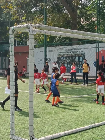 A game in progress at the Youth Super Cup, with parents watching from the sidelines. The community support is fantastic.