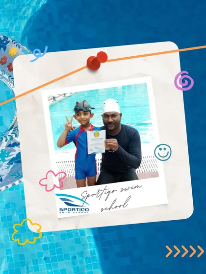 This is the moment it all comes together. A proud young swimmer receives his certificate from his coach, marking a significant achievement in his journey to becoming water-confident.