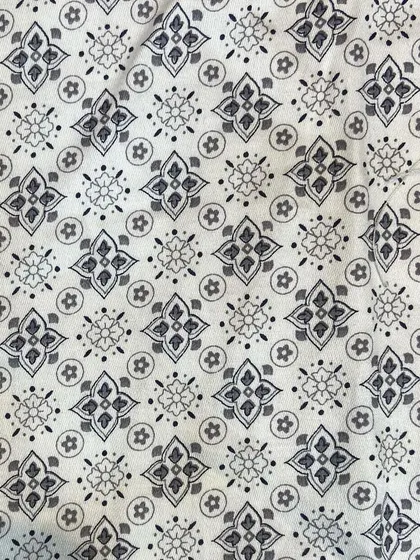 A close-up of the 100% cotton fabric used for a custom printed shirt, showing the clarity and detail of the pattern before it's cut and stitched.