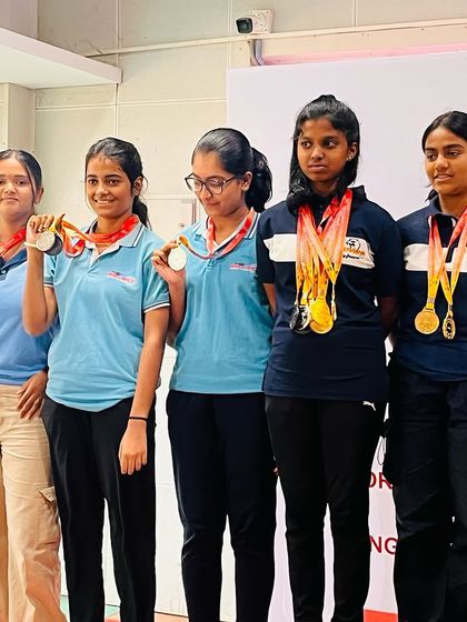 A group of our decorated women's pistol shooters on the podium.