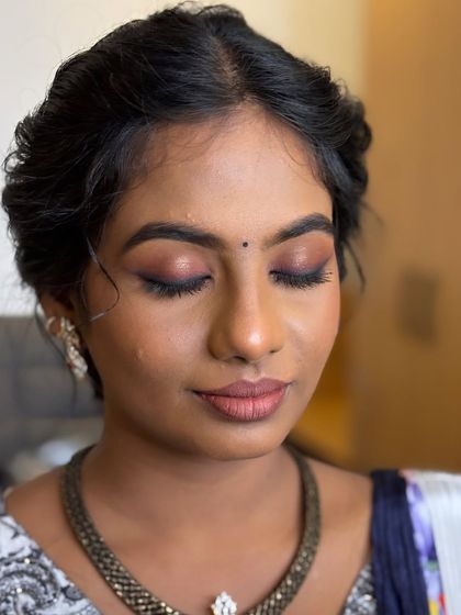 A close-up of Deekshida's engagement look. The mauve and berry-toned smokey eye is sultry and stunning, perfect for an evening event.