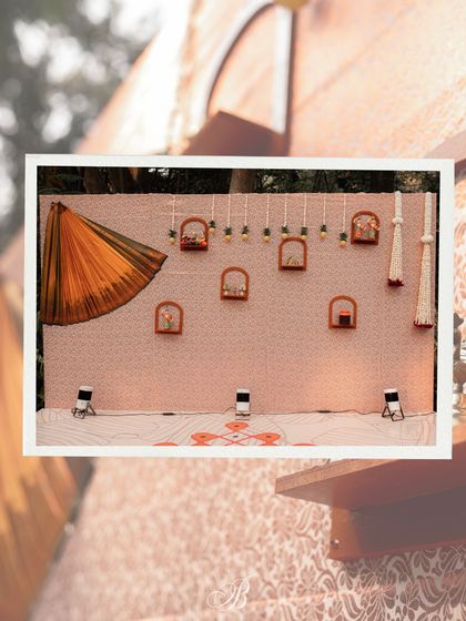 The complete band backdrop, showcasing the artful draping of the saree and the arrangement of shelves with local crafts. This setup is a perfect example of creative and sustainable event design.