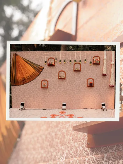 The complete band backdrop, showcasing the artful draping of the saree and the arrangement of shelves with local crafts. This setup is a perfect example of creative and sustainable event design.