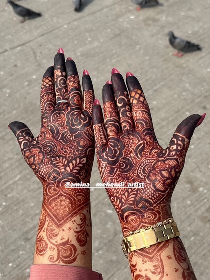 A close-up of the developed henna stain, highlighting the contrast between the fine lines and the filled-in floral motifs.