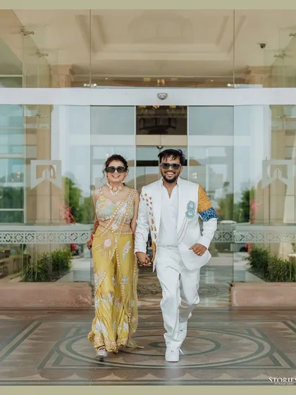 The couple making a grand entrance, walking hand-in-hand with confidence and style.