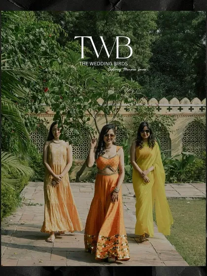 The bride and her bridesmaids posing in a beautiful garden during the haldi ceremony. Dressed in shades of yellow and orange, they look like a ray of sunshine.