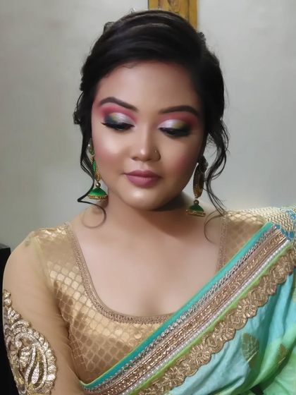 The final look, with a beautiful hairstyle and a stunning saree that complements the creative makeup.