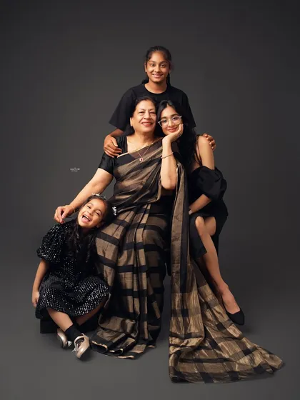 Three generations of beautiful women. A grandmother, mother, and daughters pose together, creating a strong and loving portrait that celebrates family bonds across generations.