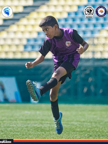 A young player strikes the ball with perfect technique against the backdrop of the stadium, dreaming of the big stage.