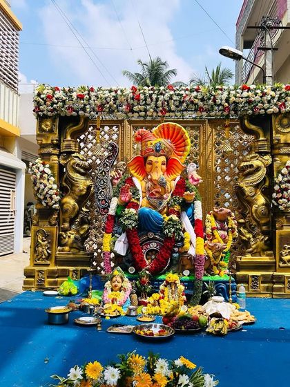 A wide-angle view of our outdoor Ganesh Chaturthi stage decoration. The setup is built on a raised platform, making it a perfect centerpiece for community festivities in Bangalore.