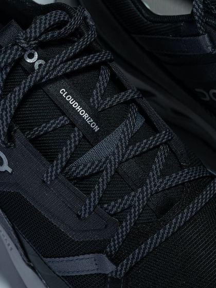 A close-up of the lacing system and 'Cloudhorizon' branding on the On Running shoe.