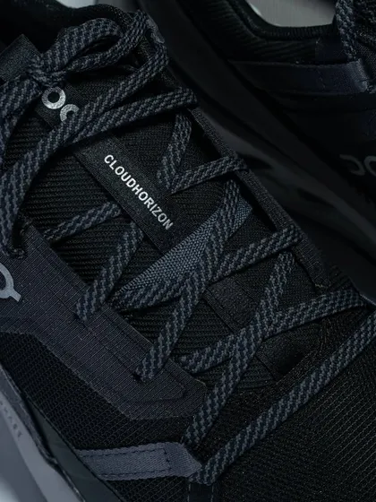 A close-up of the lacing system and 'Cloudhorizon' branding on the On Running shoe.