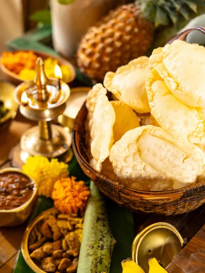 A close-up on the pappadams and other elements of the Onam feast, highlighting the textures and details of each dish.