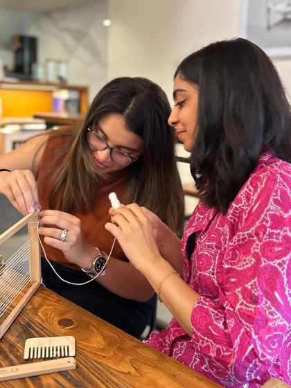 There's a wonderful sense of community in my workshops. Here, two participants are helping each other set up a loom. It’s a friendly atmosphere where people can share ideas and learn together.