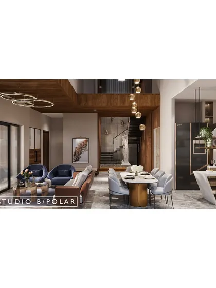 In this 5000 sqft villa in Gandhidham, we designed an open-concept living and dining area to be the heart of the home. A double-height ceiling over the dining area connects the space to the upper floors.