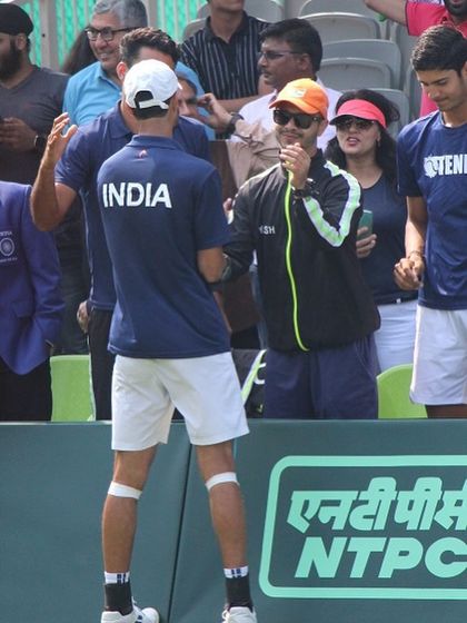 A candid moment of discussion with a player during a break in play. Constant feedback and monitoring are crucial to making real-time adjustments and keeping athletes safe and competitive.